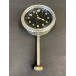 A Jaeger Swiss eight day car clock with long winding stem below.