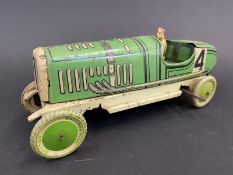 An English-made clockwork tinplate model of a 1920s racing car, complete with driver.