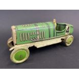 An English-made clockwork tinplate model of a 1920s racing car, complete with driver.