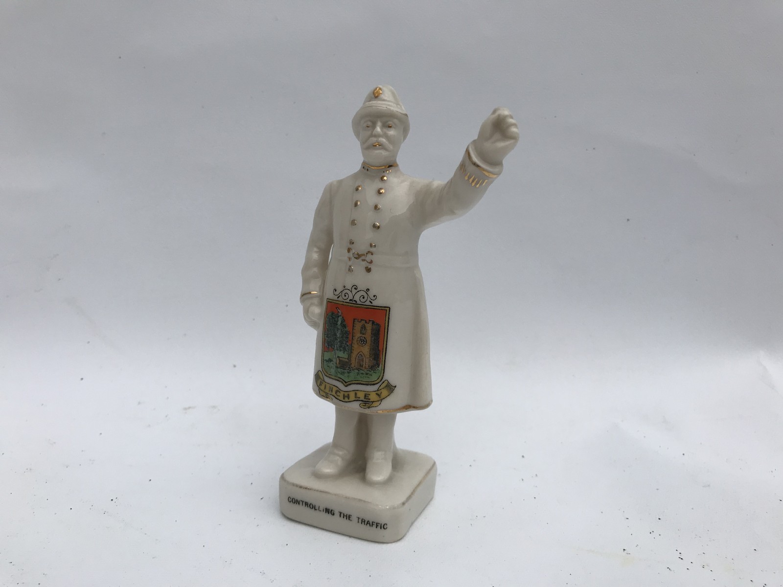 An Arcadian China crestedware model of a standing policeman advertising Finchley, titled '