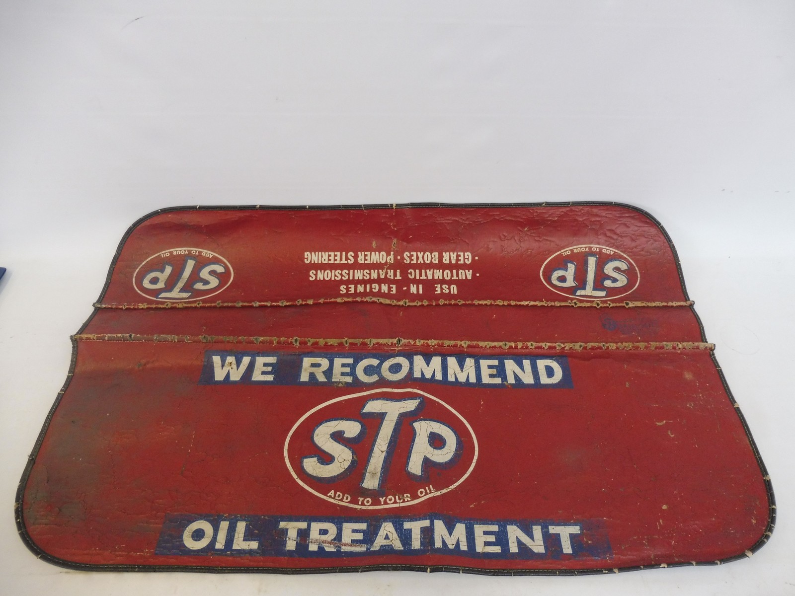 An original STP Oil mechanic's wing cover.