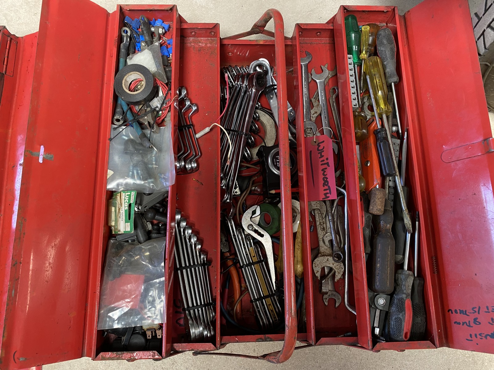 Two tool boxes containing an assortment of tools.