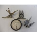 A Swallow car mascot, a Rover Viking radiator badge, a Mack mascot and a temperature gauge.