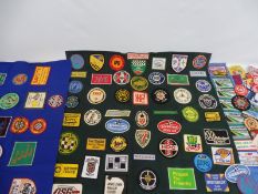 A collection of approximately 100 cloth sew-on badges relating to motorsport race meetings, car