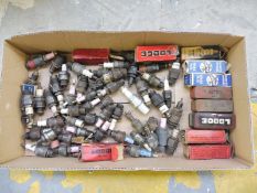 A quantity of early spark plugs, some boxed.