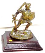 An accessory mascot in polished brass, in the form of a knight in armour.
