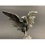 A well-detailed Vintage car accessory mascot in the form of a standing bird of prey with wings