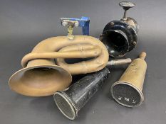 A hand Klaxon horn, a brass double twist bulb horn, lacking rubber bulb plus two horns with fly