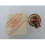 A BMC Nuffield Tractors enamel lapel badge in original paper packet.