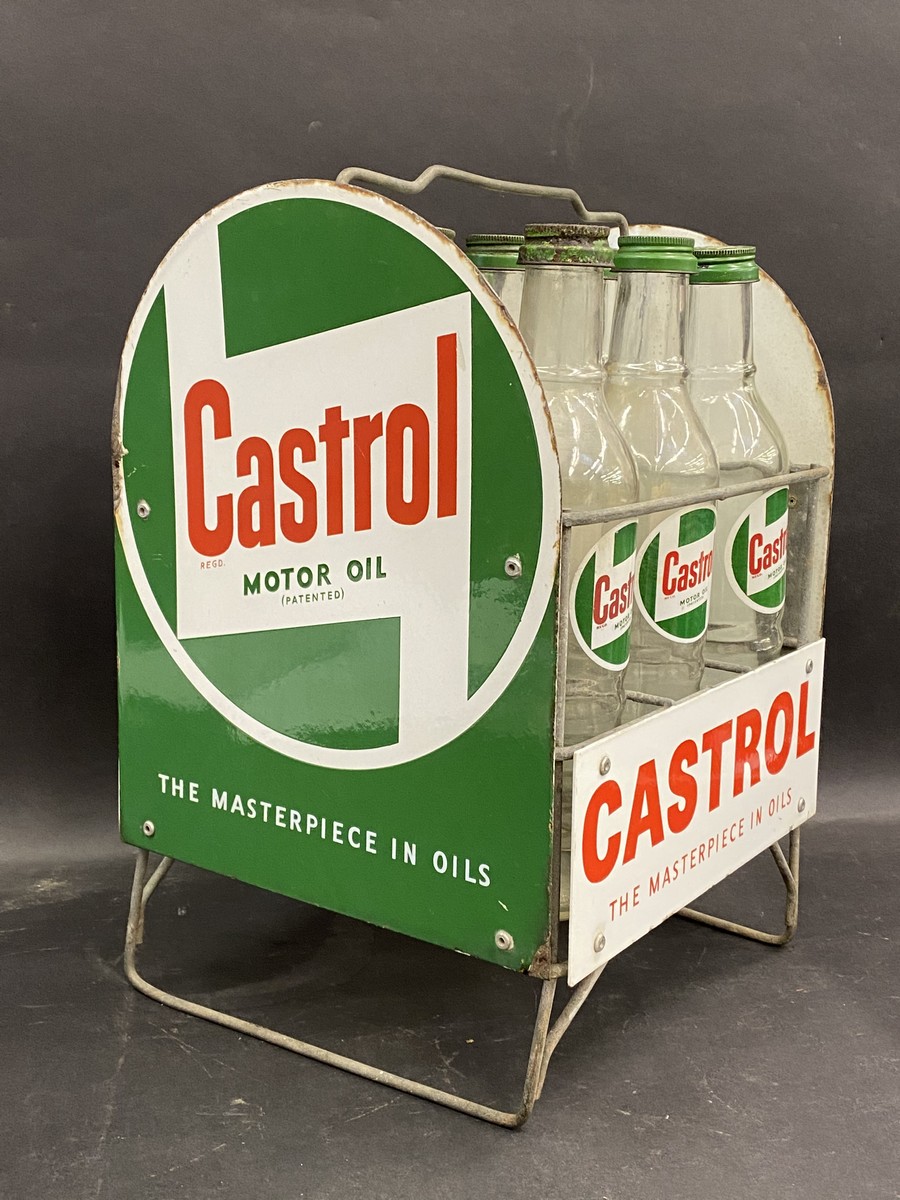 A good Castrol nine division garage forecourt oil bottle rack with enamel signs all round and nine