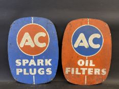 A pair of AC oval tin signs, one for Oil Filters, the other for Spark Plugs, each 12 x 16".
