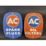 A pair of AC oval tin signs, one for Oil Filters, the other for Spark Plugs, each 12 x 16".