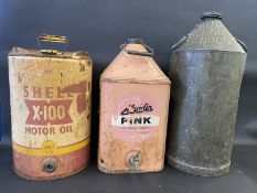 A tall Medina Refinery Ltd conical can, a Shell X-100 Motor Oil five gallon drum and another for