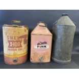 A tall Medina Refinery Ltd conical can, a Shell X-100 Motor Oil five gallon drum and another for