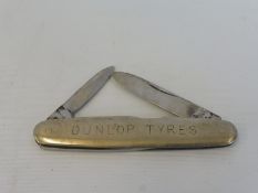 A Dunlop Tyres penknife marked to the reverse: Burns Philp (Southsea) Co. Ltd.