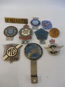A box of assorted car badges including Evesham Auto Club, West Riding Squadron Royal Auxiliary Air