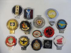 A shallow box of car badges including The Pathfinder Club, Cornwall County Fire Brigade etc.