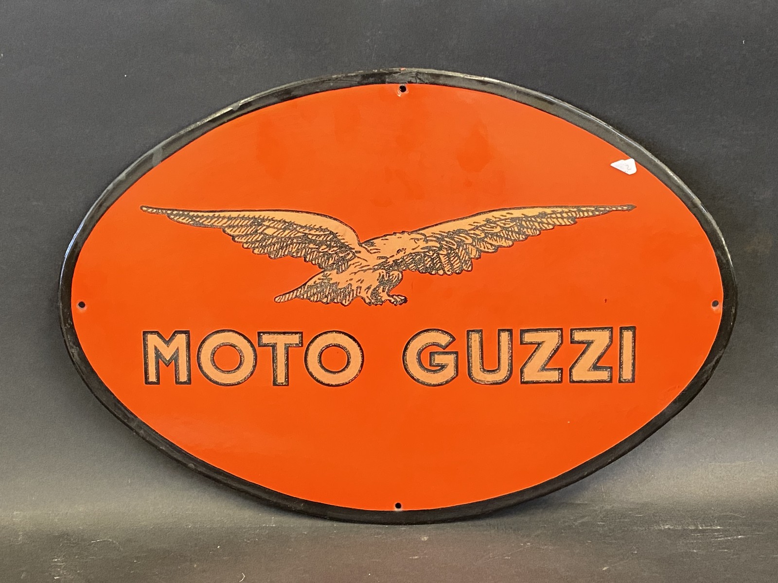 A reproduction Moto Guzzi oval advertising sign, 18 1/2 x 12 3/4".