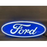 A Ford oval illuminated lightbox, in working condition, 42" w x 16 3/4" h x 4 1/2" d.