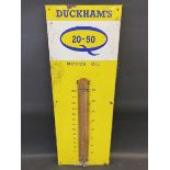 A Duckham's 20-50 Motor Oil enamel thermometer with original celluloid covering for the tube, 13 x