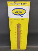 A Duckham's 20-50 Motor Oil enamel thermometer with original celluloid covering for the tube, 13 x