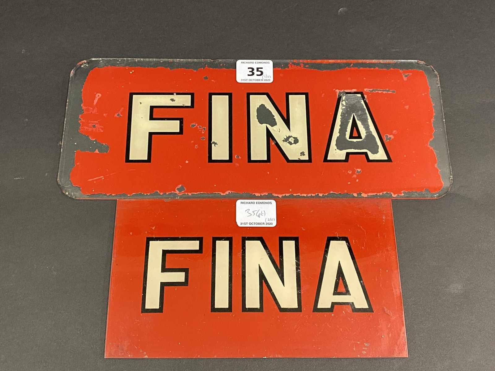 A Fina glass petrol pump brand indicator, 12 1/2 x 5" plus a plastic version, 8 1/2 x 4 3/4".