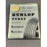 A Dunlop Tyres mirrored paperweight.