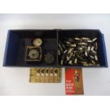 A box of mixed spark plugs and accessories plus three voltmeters.