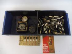 A box of mixed spark plugs and accessories plus three voltmeters.