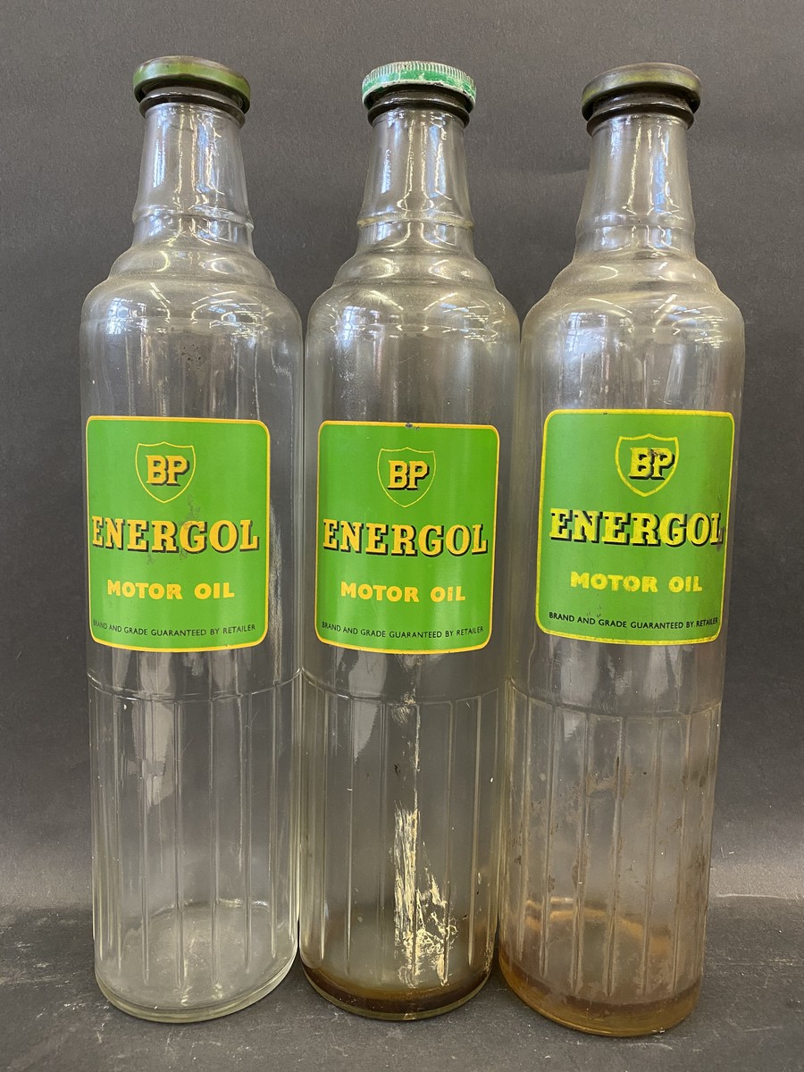 Three BP Energol Motor Oil quart glass bottles with caps.