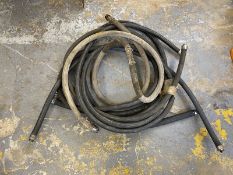 Four petrol pump hoses including one early canvas example.