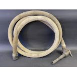 An early canvas petrol pump hose with bronze nozzle.