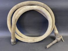 An early canvas petrol pump hose with bronze nozzle.