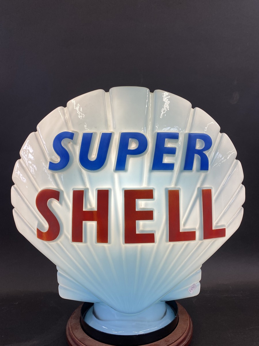 A blue Super Shell glass petrol pump globe by Hailware, fully stamped underneath 'Property of