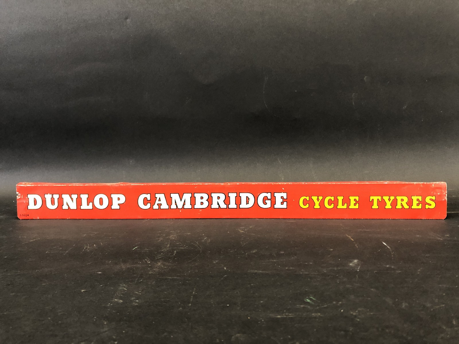 A Dunlop Cambridge Cycle Tyres shelf strip.