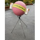 A very unusual polystyrene spherical Shell advertisement on a three footed metal stand.