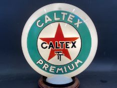 A Caltex TT Premium glass petrol pump globe by Webb's Crystal, chips to neck.