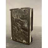 A bakelite vesta case with well-detailed embossed decoration depicting a gentleman and a lady