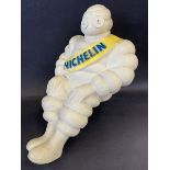 A Michelin Mr Bibendum seated advertising figure, from the top of an air pump.