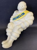 A Michelin Mr Bibendum seated advertising figure, from the top of an air pump.
