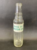 An unusual pint oil bottle bearing a label for SAE 30 Motor Oil.