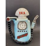 A novelty teapot in the form of a petrol pump.