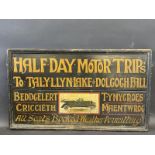 A rectangular part pictorial painted wooden sign promoting 'Half Day Motor Trips' in the North Wales