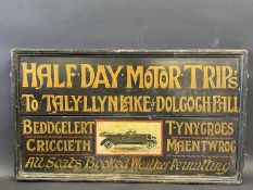 A rectangular part pictorial painted wooden sign promoting 'Half Day Motor Trips' in the North Wales