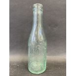 An unusual glass bottle bearing the name A.C.B Co. Ltd of Ross with an image of a petrol pump to the