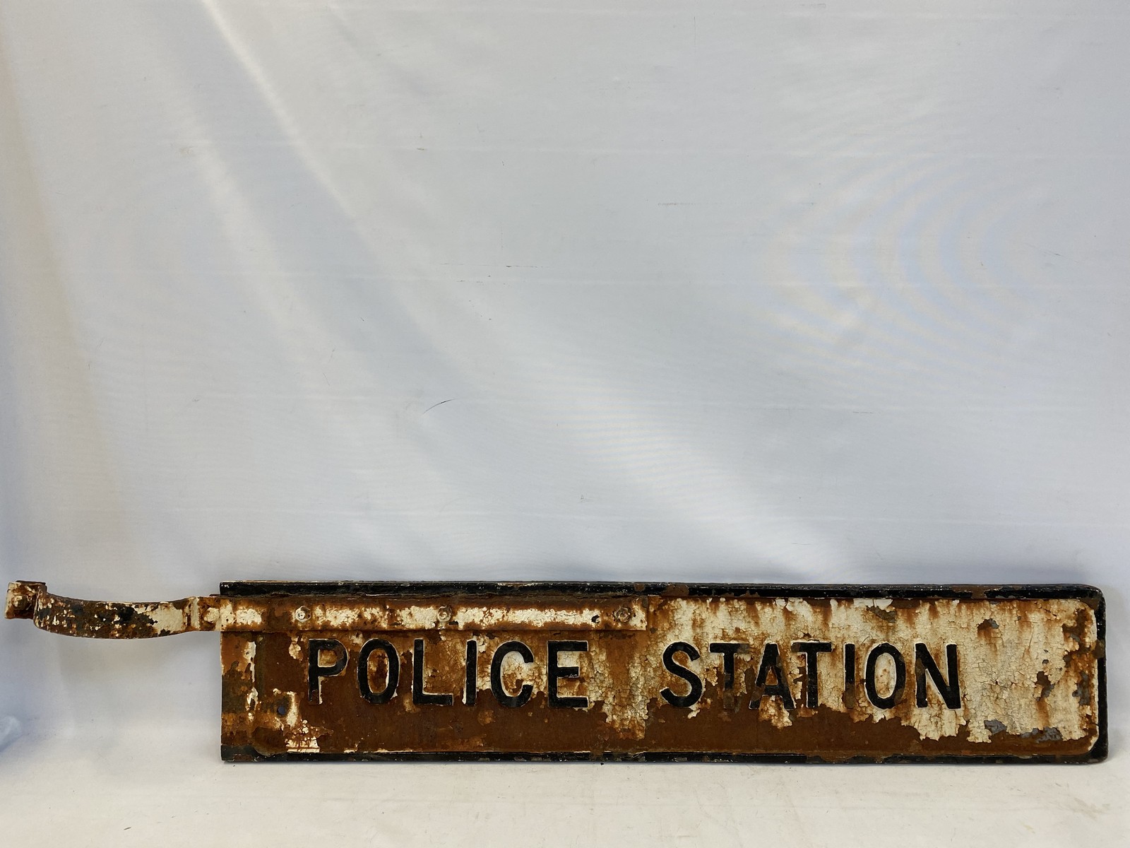 A 'Police Station' cast iron double sided directional road sign with partial bracket, 49 1/2 x 8"