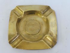 A polished brass Bugatti ashtray.