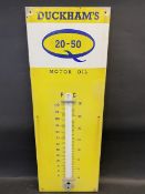 A Duckham's 20-50 Motor Oil enamel thermometer sign, lacking glass tube, 13 x 36".