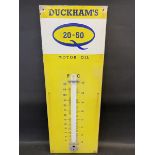 A Duckham's 20-50 Motor Oil enamel thermometer sign, lacking glass tube, 13 x 36".