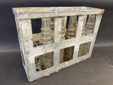 An Essolube galvanised 12 division crate containing eight Essolube pint bottles.